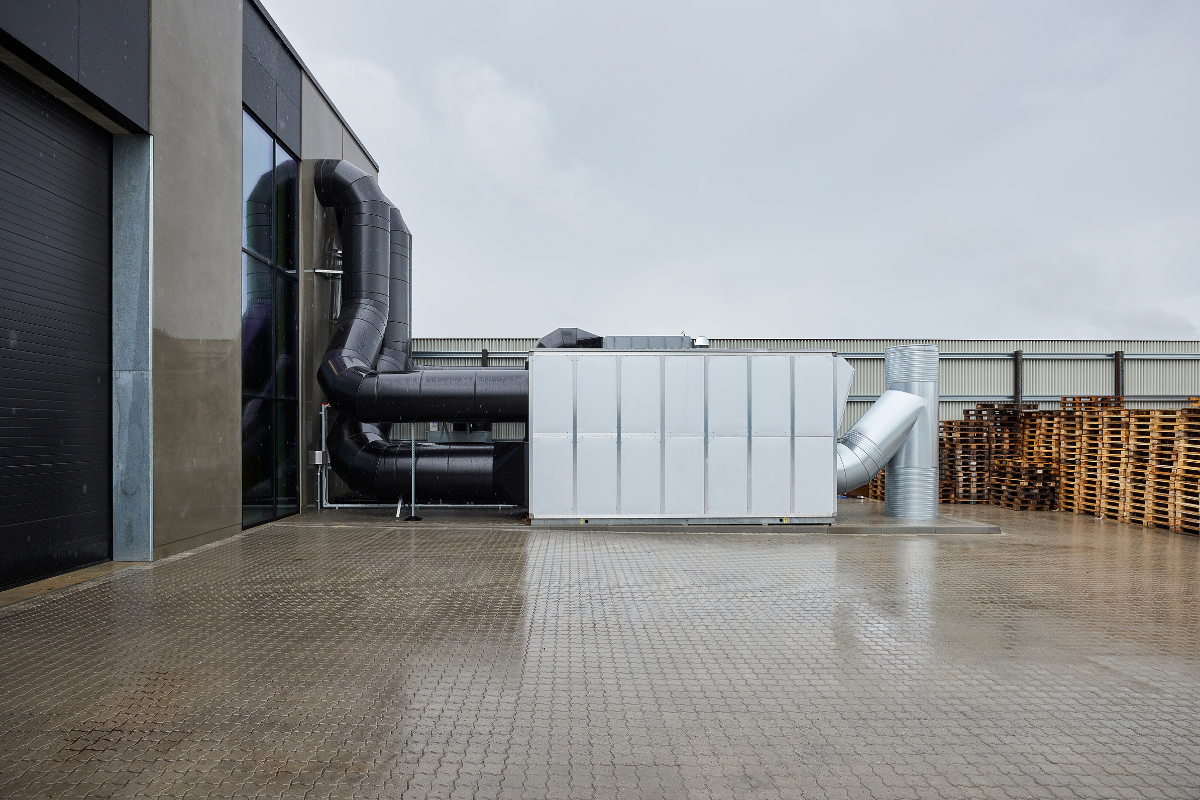 Udvendigt industriventilationsanlæg med store ventilationskanaler hos Flexi-Riste A/S i